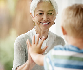 Image showing Covid, family and window with grandma and boy touching through barrier for prevention and safety showing love, care and happiness. Quarantine, coronavirus and isolation with senior woman and child