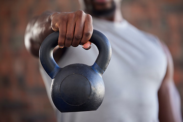 Image showing Fitness, bodybuilder and black man kettlebell training, exercise or workout for powerful arm strength at gym. African, hand and strong sports athlete bodybuilding or weightlifting in a health club