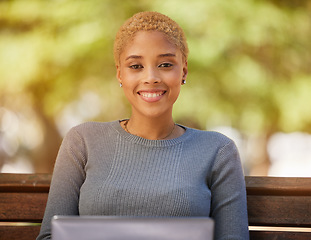 Image showing Laptop, smile and woman with internet at a park, working and typing with 5g web connection on a bench. Portrait of a young, happy and freelance worker with a computer for business online in nature