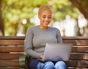 Image showing Happy black woman, laptop and outdoor relax in sunshine on bench in city, online job search or remote work in park. Young girl smiling, creative writer or copyright designer on 5g zoom meeting app