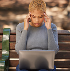 Image showing Black woman, laptop and stress for exams, being anxious and headache for studies, outdoor and on bench. Female student, young lady and with digital device with anxiety, for results and burnout.