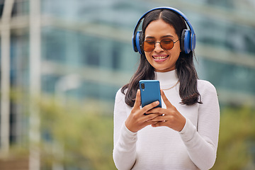 Image showing Phone, woman and music in a city with happy, relax and smiling female walking, texting and chatting online. Radio, podcast and audio streaming with trendy lady enjoying subscription service in town