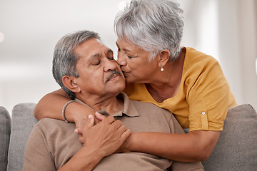 Image showing Kiss, love and senior couple in the living room of their house during retirement together. Happy, loving and elderly man and woman with affection, support and help in marriage on the sofa in home