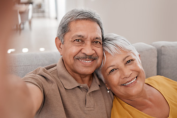 Image showing Selfie, couple and love with a senior man and woman sitting on the sofa of their home together for a photograph. Portrait, love and smile with elderly pensioners taking a picture in the living room