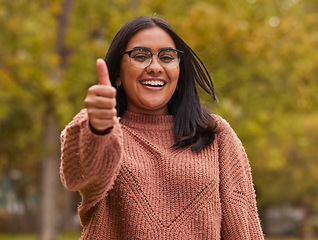 Image showing Thumbs up, like and Indian woman in park for outdoor support, volunteer in eco environment or green success. Thank you, yes or ok agreement hand sign of a girl in portrait with countryside trees