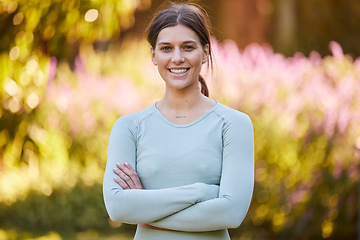 Image showing Smile, fitness and woman training in nature for health, cardio and morning motivation. Portrait of young, happy and calm athlete with arms crossed, pride in workout and wellness journey with exercise