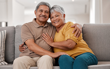 Image showing Hug, portrait and senior couple on the sofa in the living floor to relax during retirement in their house. Happy, smile and love from elderly man and woman with affection on the couch in their home