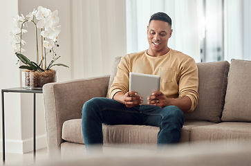 Image showing Man, tablet and social media on sofa in home, internet surfing or web browsing. Happy, relax and male from India on digital tech, mobile app or streaming content, movie or online video in house alone