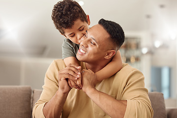 Image showing Kiss, child and father with hug on the sofa for love, care and happiness in the living room together in their house. Young, happy and kid with smile, affection and hugging his dad on the couch