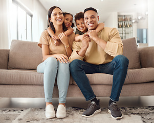 Image showing Hug, children and parents on the sofa in their living room for care, love and smile together in house. Portrait of happy, relax and young kids hugging mother and father with affection on the couch