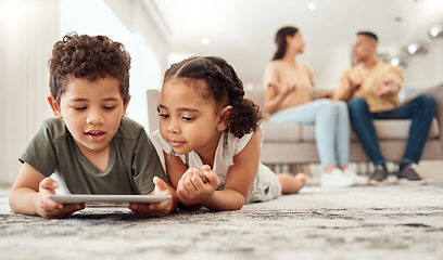 Image showing Kids on floor with tablet in living room, watching fun and educational videos or playing game online with parents on sofa. Technology, internet and children play on carpet with mobile app together.