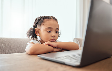 Image showing Children, laptop and education with a girl learning from home online for growth or development. Computer, internet and study with a female child distance learning at a dining room table in the house