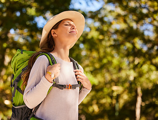 Image showing Hiking, travel and woman backpacking in the forest for outdoor wellness, adventure or eco friendly lifestyle. Breathing, trekking and carbon footprint girl with backpack gear in woods, park and trees