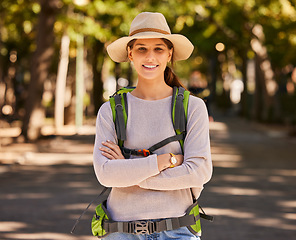 Image showing Portrait, hiking and woman in hat arms crossed on holiday, vacation or trip. Travel, freedom and female from Canada on hike, explore or adventure outdoors in nature, having fun or spending time alone