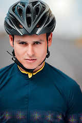 Image showing Cycling, helmet and serious with a sports man outside, ready to ride or cycle for exercise and fitness. Workout, training and cardio with a male athlete riding with focus for health or endurance
