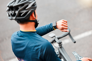 Image showing Watch, fitness and man cycling in the city on a bike for cardio health, exercise and sustainable lifestyle. Athlete cyclist training with the time on tech with a bicycle on the street for motivation