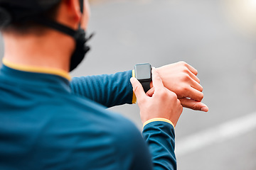 Image showing Watch, fitness and man doing a workout, exercise or outdoor cardio in the city road for motivation. Hands of an athlete with monitor of time during training with sports technology in the street