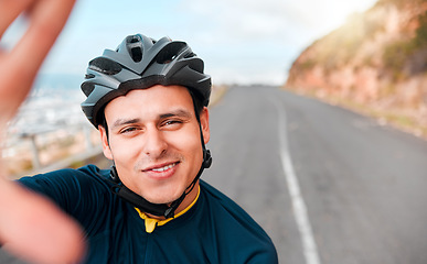 Image showing Selfie, fitness and man cycling in the road on the mountains in Switzerland for adventure, peace and freedom. Face portrait of a young, happy and free athlete with photo while training in the street