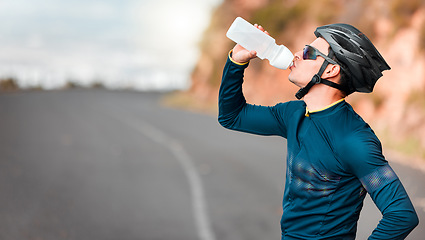 Image showing Road, fitness and cycling man drinking water by a mountain tired from workout, cardio exercise and training. Bicycle, sports and thirsty biker refreshing with a healthy beverage or liquid in Texas