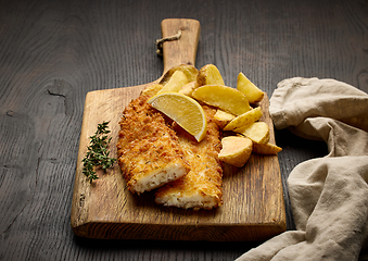 Image showing breaded fish fillets and fried potato wedges