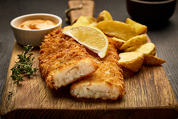 Image showing breaded fish fillets and fried potato wedges