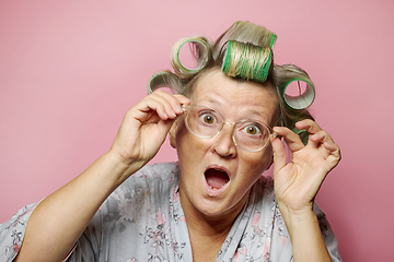 Image showing surprised senior women with hair rollers