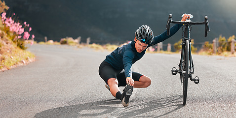 Image showing Cycling, stretching and street with a sports man stopping on an asphalt road for a stretch during a ride. Bicycle, helmet and prepare with a male athlete outdoor for bike fitness or exercise