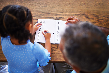 Image showing Education, homework and family with a girl and father writing in a notebook for school, learning or development. Study, help and student with a female child studying with her dad at home from above