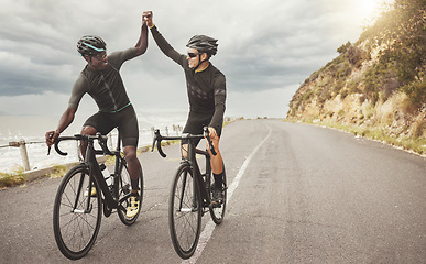 Image showing Bike, friends and men high five on road having fun cycling together outdoors. Success, diversity and teamwork of male cyclists on bicycles riding on street, exercise or workout training on asphalt.