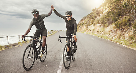 Image showing Fitness, high five and friends cycling on the road for cardio exercise, sports training and bicycle workout. Successful, diversity and happy athletes or bikers riding by mountain with pride together