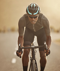 Image showing Fitness, sports and cycling man workout in a road at sunset, health, wellness and morning cardio exercise. Energy, speed and focus power by athletic black man cycling on bicycle for marathon training