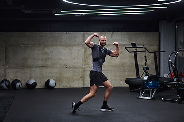 Image showing Muscular man posing in a modern gym