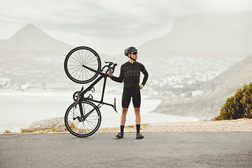 Image showing Fitness, sports and cycling man with his bike on a mountain road for health, wellness and morning cardio exercise. Athlete male with outdoor for energy, workout and marathon training with a bicycle