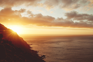 Image showing Sunset, sea and clouds with a view of the beautiful ocean or horizon during summer outdoor. Water, nature and sunrise with a picturesque scene of the earth, mountain or cloudy skin outside in the day