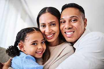 Image showing Family, happy and face portrait in living room home, smiling and bonding. Love, care and happy parents, child or girl hugging, embrace or spending quality time together in house with smile or support