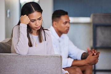 Image showing Sad, woman and couple in unhappy marriage from argument, fight or disagreement on living room sofa at home. Upset female with married problems, trouble or issues with husband in divorce or breakup