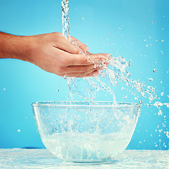 Image showing Water bowl, health and hands splash liquid for hygiene, cleaning and wellness beauty routine with mockup. Water splash container, skincare and wet palm of self care man isolated on blue background