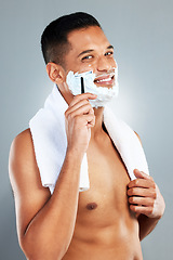 Image showing Man shaving face, razor and shower for hair removal, aesthetic skincare and facial cleaning on grey studio background. Portrait happy naked guy, shave foam and body cream cosmetics for wellness
