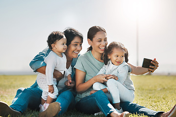 Image showing Phone, selfie and family with a woman, girl and sister taking a photograph while enjoying a summer picnic on a field of grass. Love, grandmother and generations with a mother posing for a picture