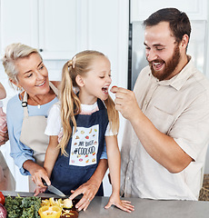 Image showing Family, tomato and feeding with a girl and father eating a vegetable in the kitchen of their home together. Food, love and health with a man giving his daughter a healthy snack while cooking inside