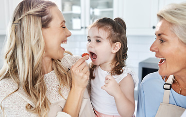 Image showing Family, feeding and tomato with a girl and mother eating together in their home while grandmother comes to visit. Food, children and vegetables with a woman giving a daughter something healthy to eat