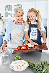 Image showing Cooking, child and grandmother teaching a girl our to cook healthy food with nutrition in the kitchen of their house. Happy, smile and young kid learning about vegetables with an elderly woman