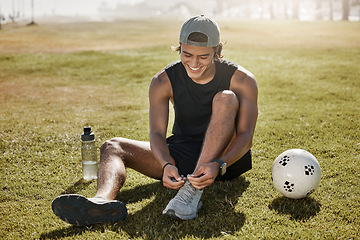 Image showing Sports, football and man tie shoes lace before game, competition or fitness exercise on outdoor grass field. Wellness health, ball and athlete soccer player prepare for workout, training or cardio