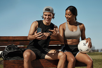 Image showing Sports friends, phone and relax while sitting in a park together, bond and laughing at social media post before morning cardio. Fitness, couple and online entertainment on park bench after training