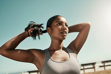 Image showing Woman tying her hair before an outdoor workout for fitness, health and wellness in nature. Training, sports and healthy girl athlete from Mexico preparing for a run or cardio exercise in a field.