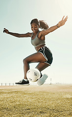 Image showing Soccer, skill and athlete jumping with a ball during an outdoor match on a sports field in South Africa. Football, trick and healthy woman practicing fitness and exercise at sport training or game.