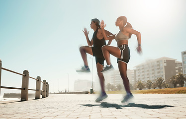 Image showing City fitness, woman or man jumping in cardio exercise, workout or training for hearth health, speed or coordination. Sports people, runner friends or couple and energy in high knees wellness warm up