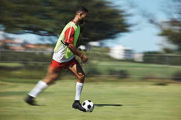 Image showing Soccer, sports and man athlete in a football game on sport field running fast and kick in nature. Fitness, training and health exercise of a workout match run with a player energy and motivation