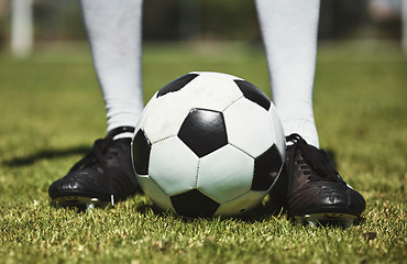 Image showing Soccer ball, football player and game of athlete on a sports field for a match wearing shoes. Fitness, training exercise and cardio health of male feet with energy on field, green grass or pitch