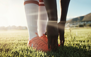 Image showing Soccer player, stretching legs on grass and hands on shoes on pitch for sport fitness training start. Football, health and wellness workout for exercise warm up before Brazil summer game competition